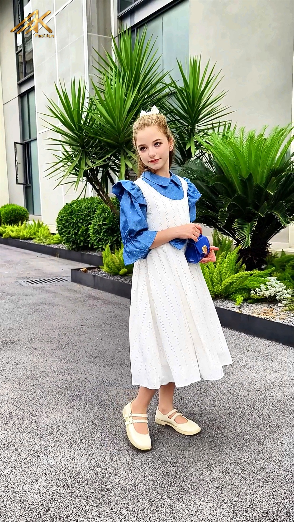 Blue dress styled with a small blue handbag