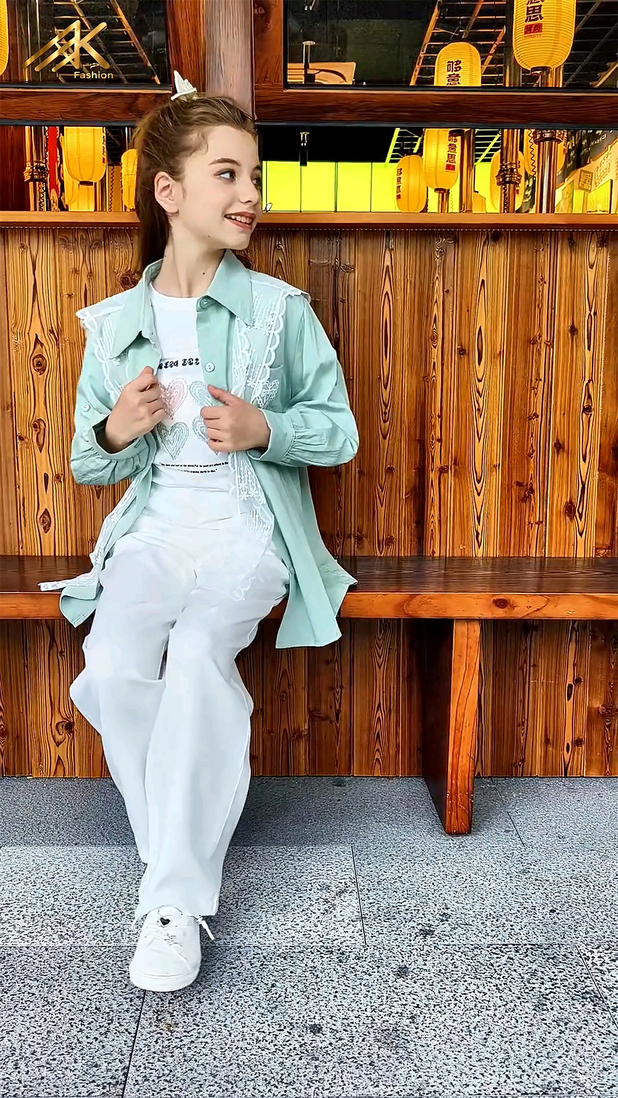 Sage green shacket with graphic tee and white trousers