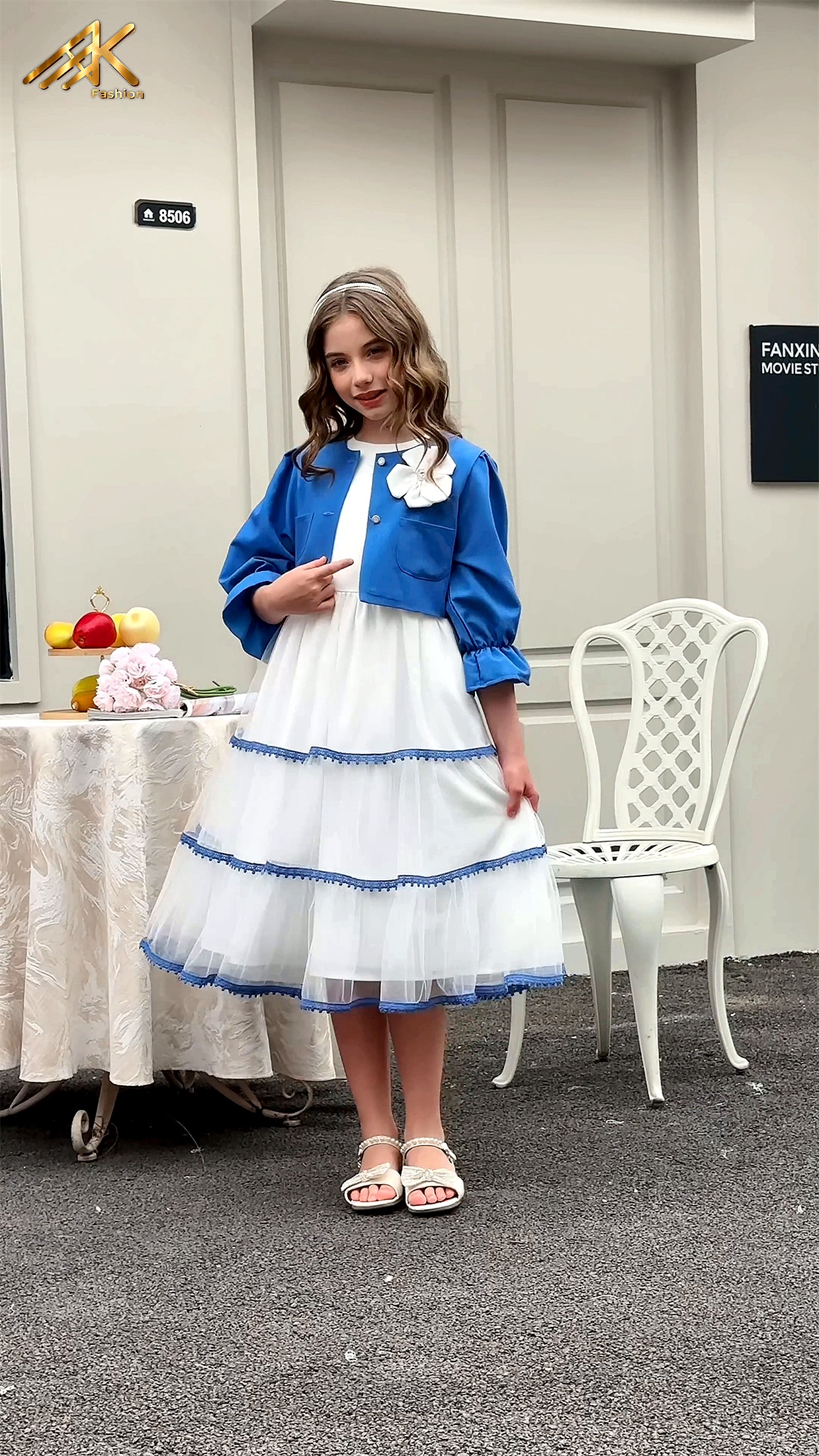 Blue jacket with white tiered tulle dress