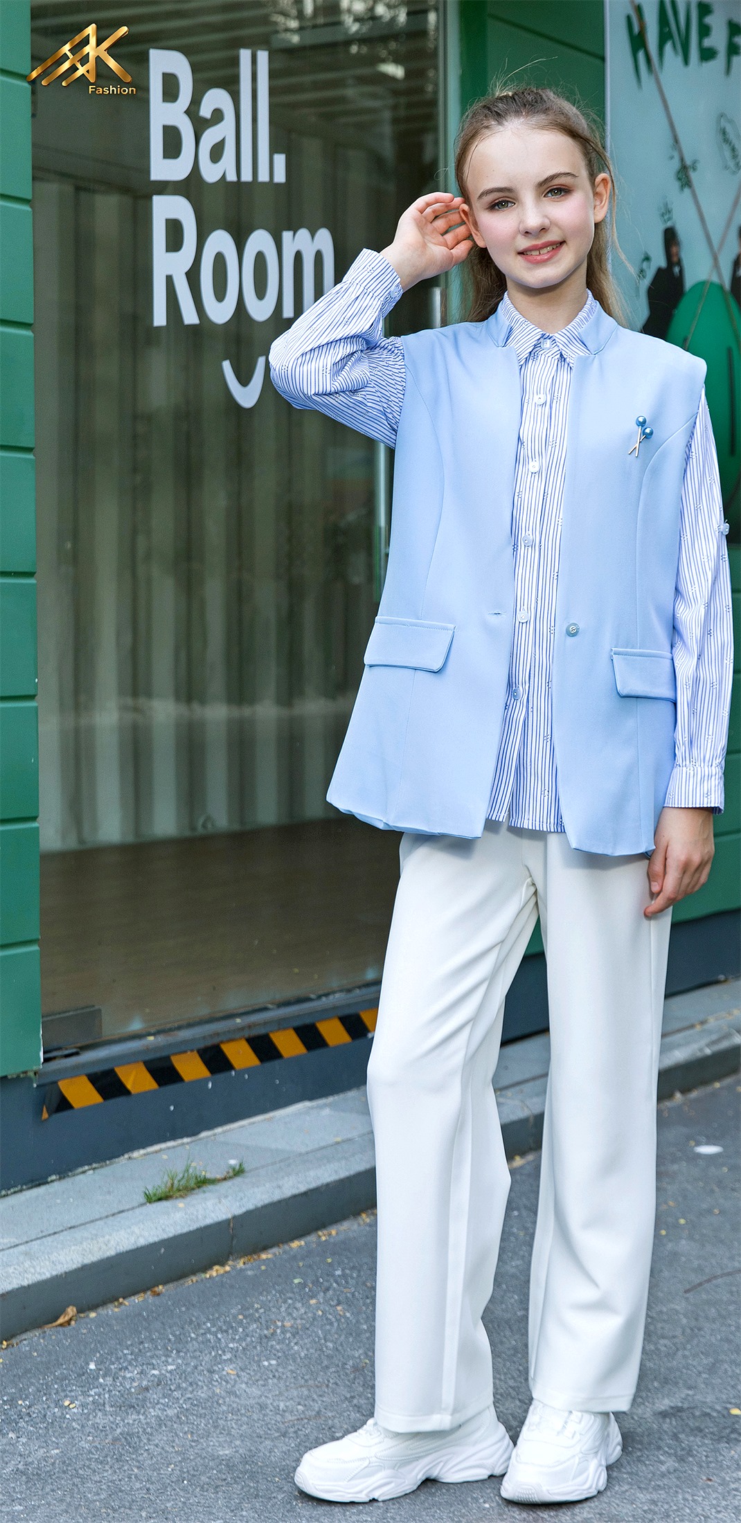 Blue vest with striped shirt and cream trousers
